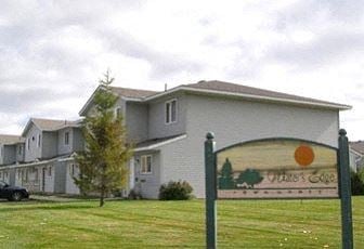Howard Lake apartment for rent - a large white house with a sign in front of it