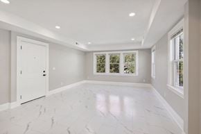 Minneapolis apartment for rent - A spacious room with white marble flooring and a large window.