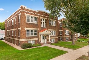 Minneapolis apartment for rent - a red brick building with a sidewalk in front of it