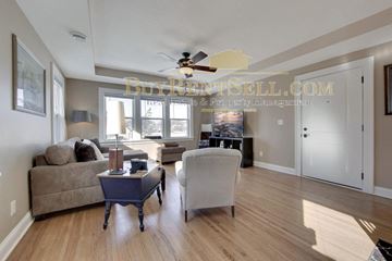 Minneapolis apartment for rent - a living room with a couch and a chair and a ceiling fan