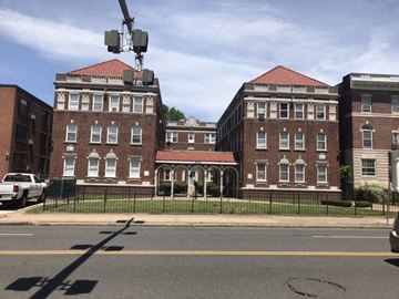Hartford apartment for rent - A large red brick building with a white trim and a red roof.