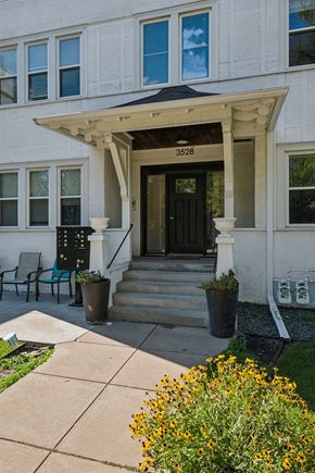 Minneapolis apartment for rent - A white building with a black door and a number 3528 on the top.