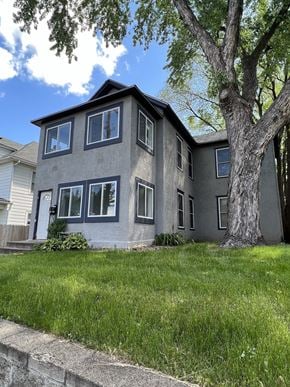 Minneapolis apartment for rent - a gray house with a tree in front of it