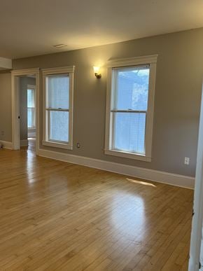 Minneapolis apartment for rent - an empty living room with wood floors and two windows