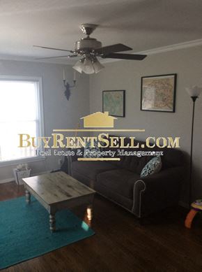 Minneapolis house for rent - A living room with a BuyRentSell.com logo on the wall.
