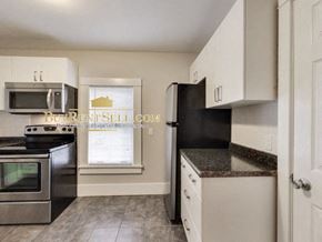 Minneapolis apartment for rent - a kitchen with stainless steel appliances and white cabinets