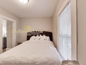 Minneapolis apartment for rent - a bedroom with a large white bed and a window