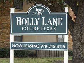 Bay City apartment for rent - A sign for Holly Lane Fourplexes with a phone number for leasing.