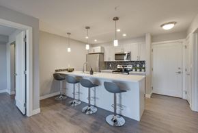 Edmonton apartment for rent - a kitchen with a bar and stools