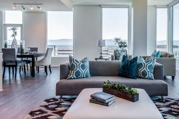 San Jose apartment for rent - A living room with a grey couch and a white coffee table.