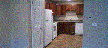Bristol apartment for rent - a kitchen with white appliances and wooden cabinets