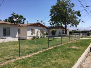 San Bernardino apartment for rent - a house with a yard and a fence in front of it