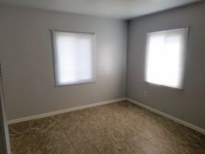 San Bernardino apartment for rent - an empty room with two windows and a tiled floor