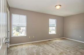 Cumberland apartment for rent - a living room with a carpeted floor and two windows