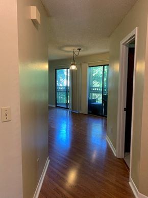 Niceville house for rent - A long hallway with a door on the right and a window on the left.