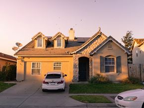 Santa Maria apartment for rent - A white car is parked in front of a house with a stone facade.