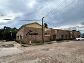 Bay City apartment for rent - A brick building with a sign that says "Chateau" is in front of a cloudy sky.