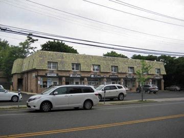 Port Washington apartment for rent - a building with a roof and cars parked in front of it