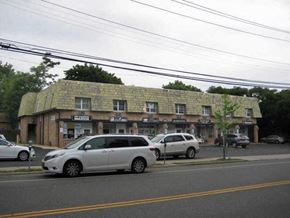 Port Washington apartment for rent - a building on the side of a street with cars