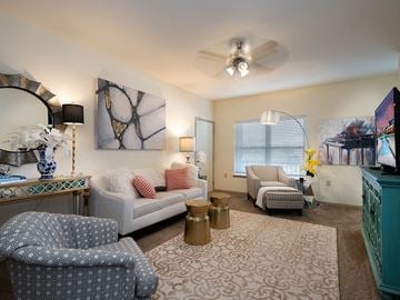 Lawrence apartment for rent - a living room with furniture and a ceiling fan