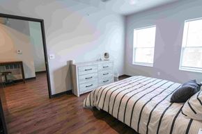 Ankeny apartment for rent - A bedroom with a bed, dresser, and mirror.