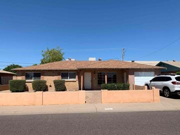 Scottsdale house for rent - a small brick house with a car parked in front of it