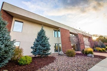 Colorado Springs apartment for rent - A modern building with a red brick facade and the number 1251 on it.