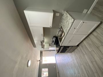 Phoenix apartment for rent - A view of a room with a ceiling fan and a light fixture.