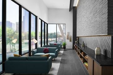 Phoenix apartment for rent - a living room with blue couches and a large window