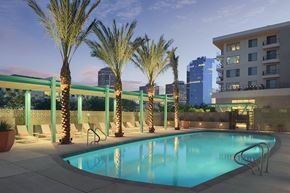 Phoenix apartment for rent - a swimming pool at a hotel with a city in the background