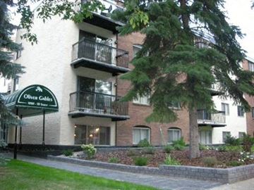 Edmonton apartment for rent - a apartment building with a tree in front of it