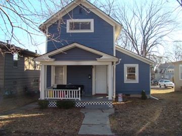 Lawrence apartment for rent - A blue house with a white door and a small porch.