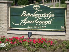 Portage apartment for rent - a sign at the front of a building with flowers