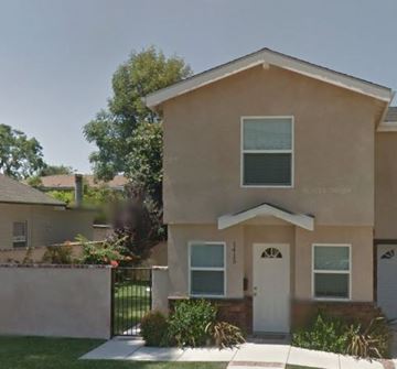 Monrovia apartment for rent - A beige house with a white door and windows.