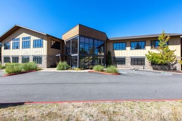 Gig Harbor apartment for rent - A large building with a parking lot in front.