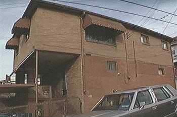 Glassport apartment for rent - A brown building with a car parked in front.