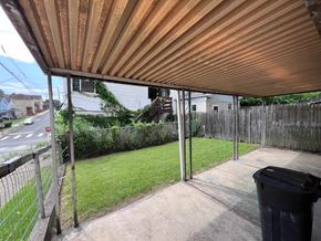 Glassport apartment for rent - A patio with a trash bin and a fence.