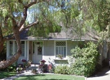 Claremont apartment for rent - A house with a white door and windows surrounded by greenery.