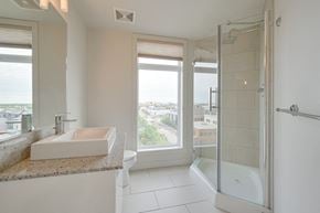 Edmonton apartment for rent - a bathroom with a sink and a shower and a window