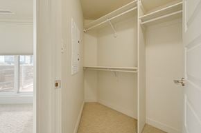 Edmonton apartment for rent - a walk in closet with a white door and a window