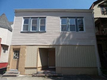 East Orange apartment for rent - A two-story house with a garage on the ground floor.