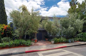 West Hollywood apartment for rent - the front of a building with trees and a sidewalk