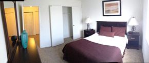 Anderson apartment for rent - A bedroom with a large bed and a painting on the wall.