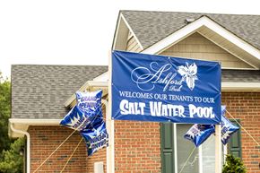Duncan apartment for rent - A blue banner with white text welcomes tenants to a salt water pool.