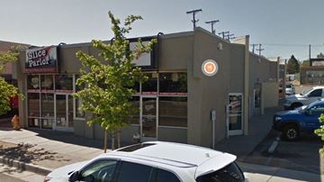 Albuquerque apartment for rent - A white car is parked in front of a building with a sign that says "Silice Parlor".