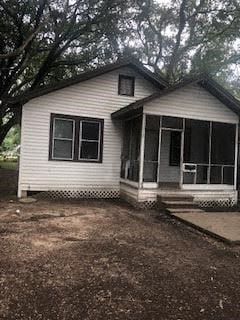Baton Rouge house for rent - A small white house with a porch and a covered entry way.