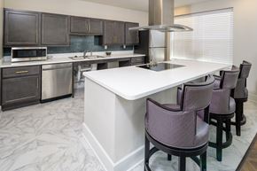 Elsmere apartment for rent - a kitchen with a large island with chairs and a counter top