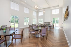 Elsmere apartment for rent - a dining room with tables and chairs and large windows