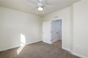 Elsmere apartment for rent - a bedroom with a ceiling fan and a door to a closet