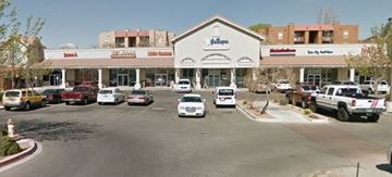 Albuquerque apartment for rent - A parking lot in front of a store with cars parked.
